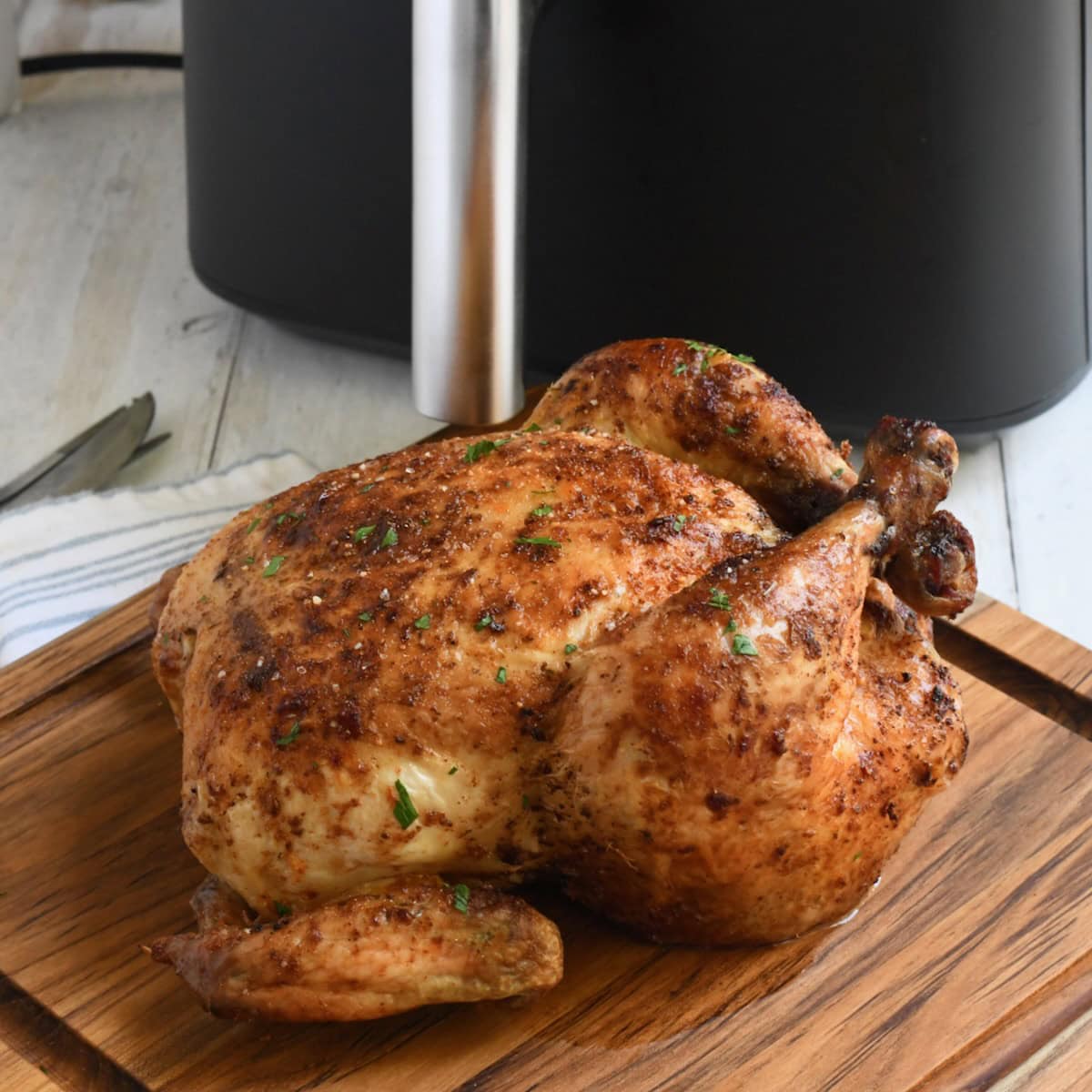 Roasted whole chicken by an air fryer.