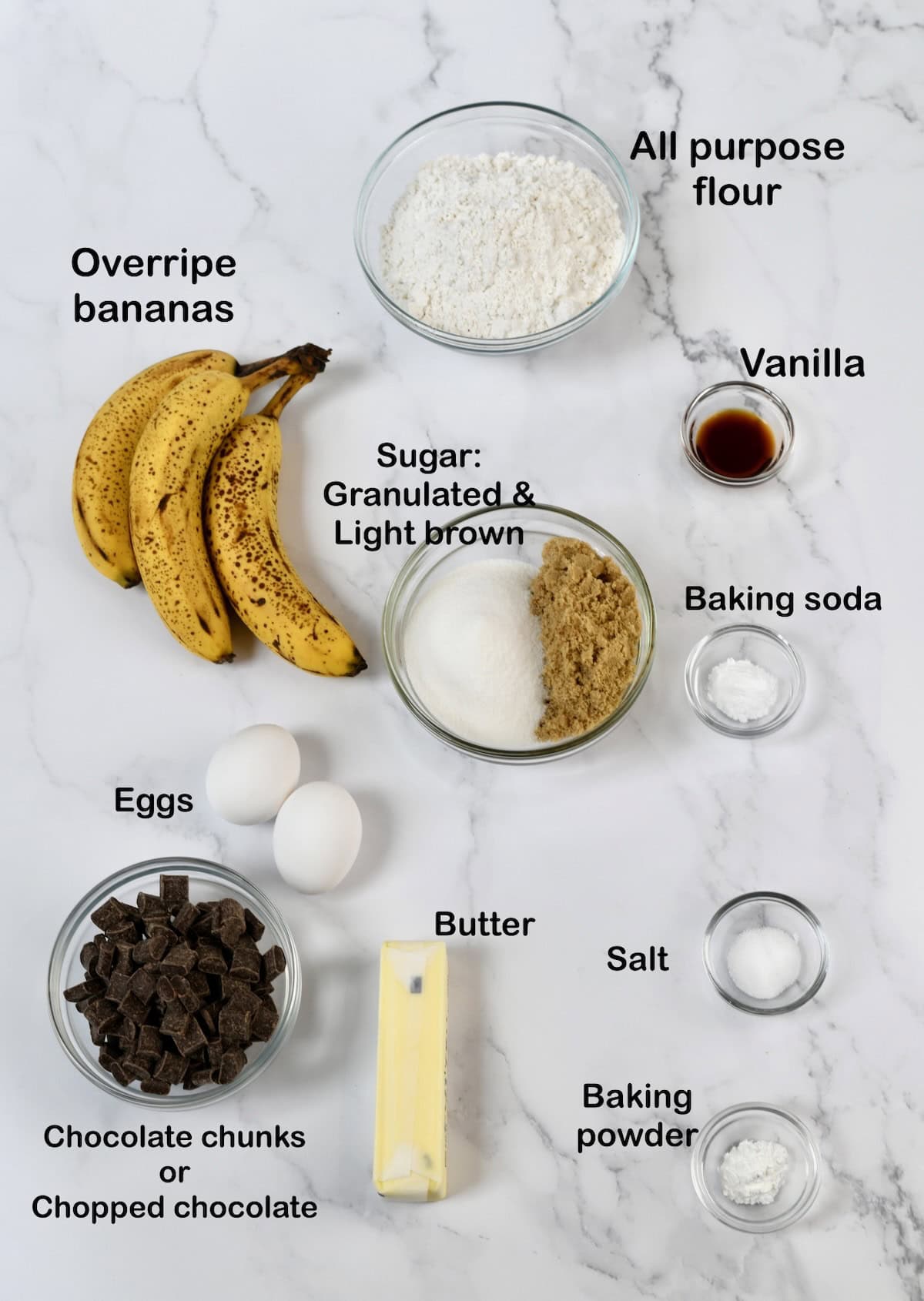 Ingredients for Chocolate Chunk Banana Muffins, labeled with bananas, flour, butter, baking soda eggs, salt, baking powder.
