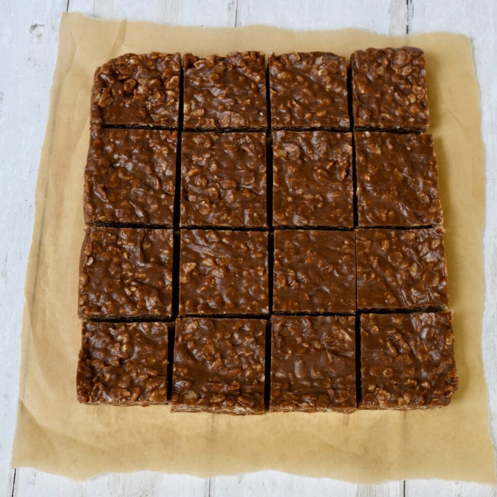 chocolate peanut butter rice crispy treats cut into 16 squares.