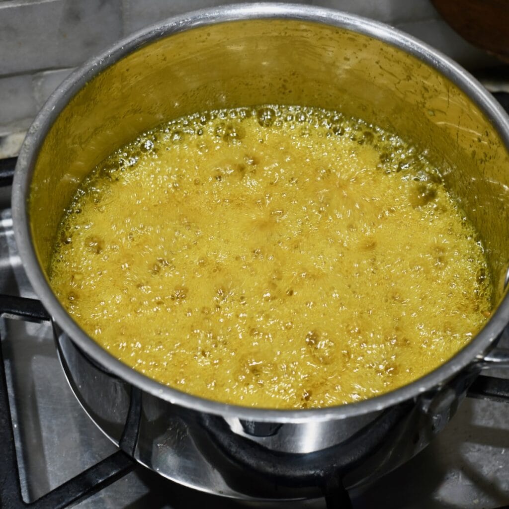 Candy mixture boiling in saucepan for cowboy candy.
