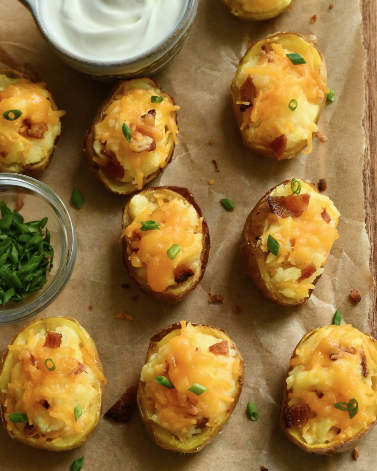 Mini twice baked potatoes topped with melted Cheddar cheese and chives