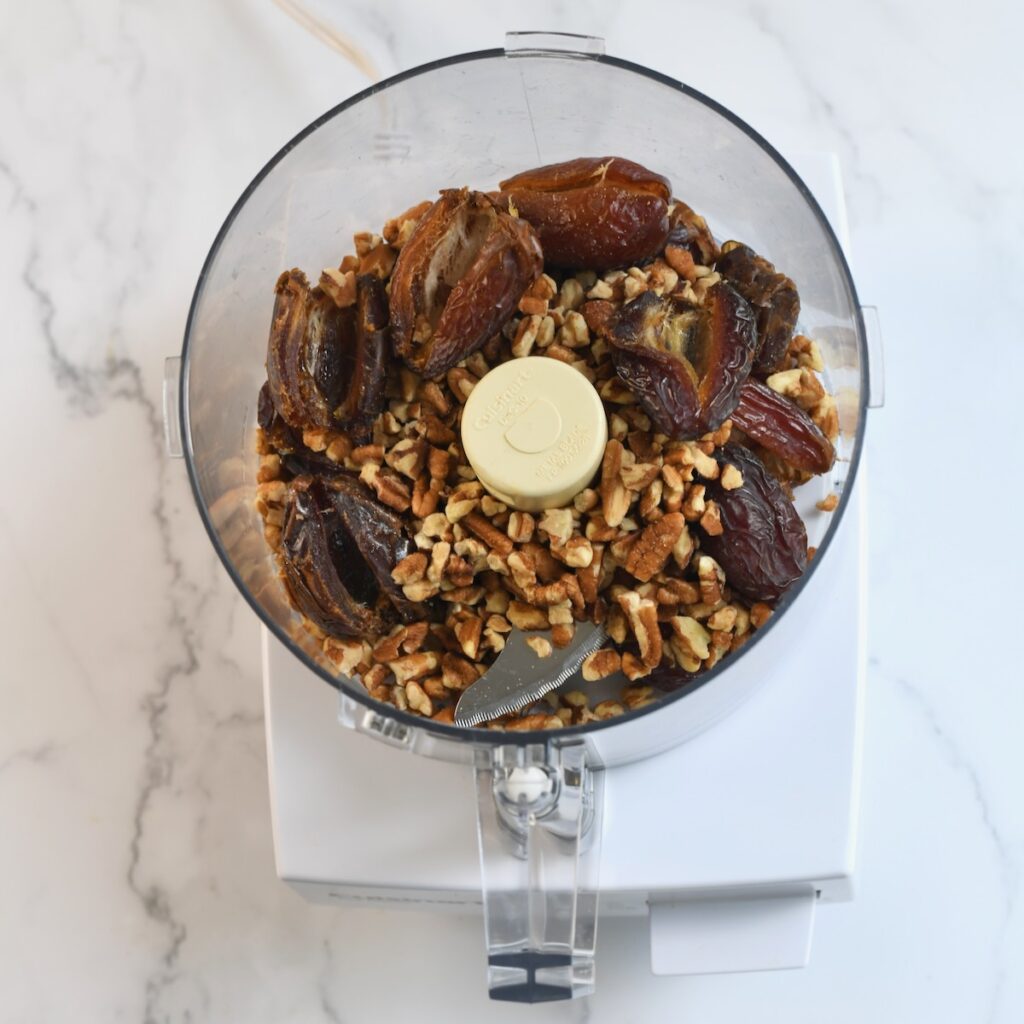Medjool dates and pecans in a food processor before blending