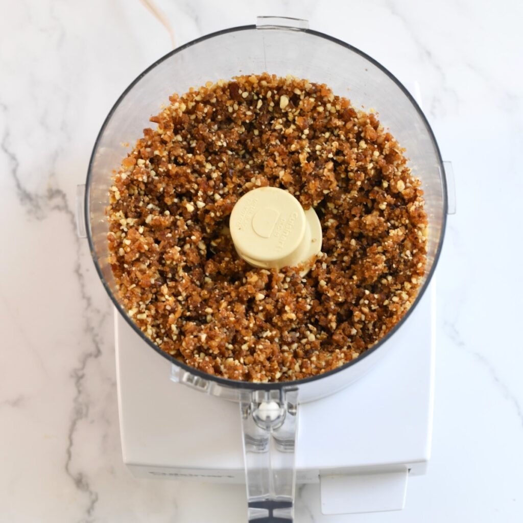 Blended mixture of dates and pecans in a food processor