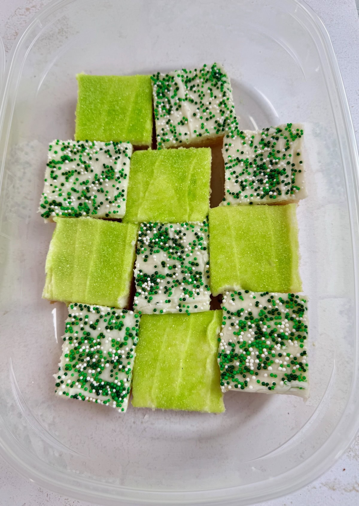 Sugar Cookie Bar Cookies with green sanding sugar and green and white sprinkles on top.
