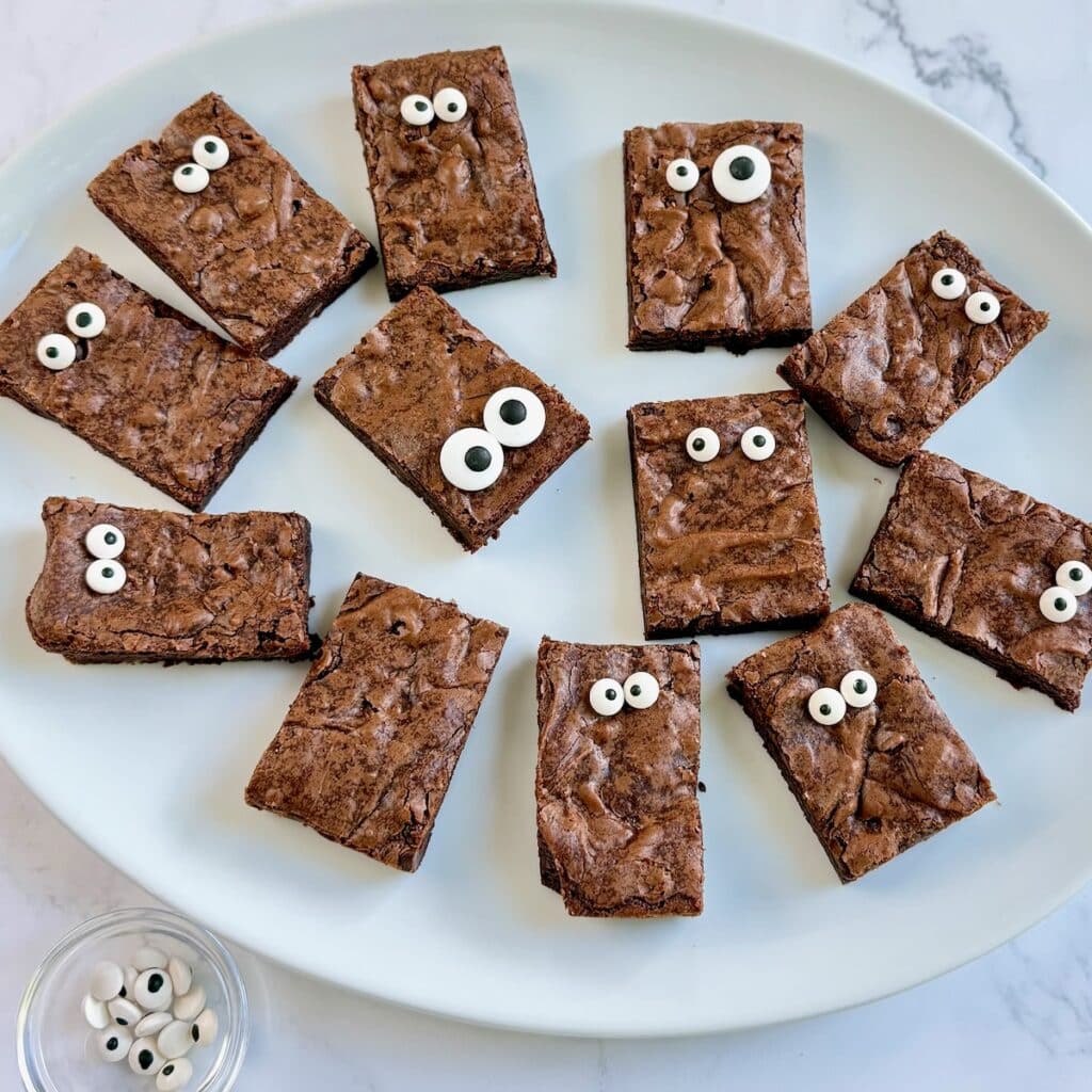 Brownies cut in bars with candy eyes on them.