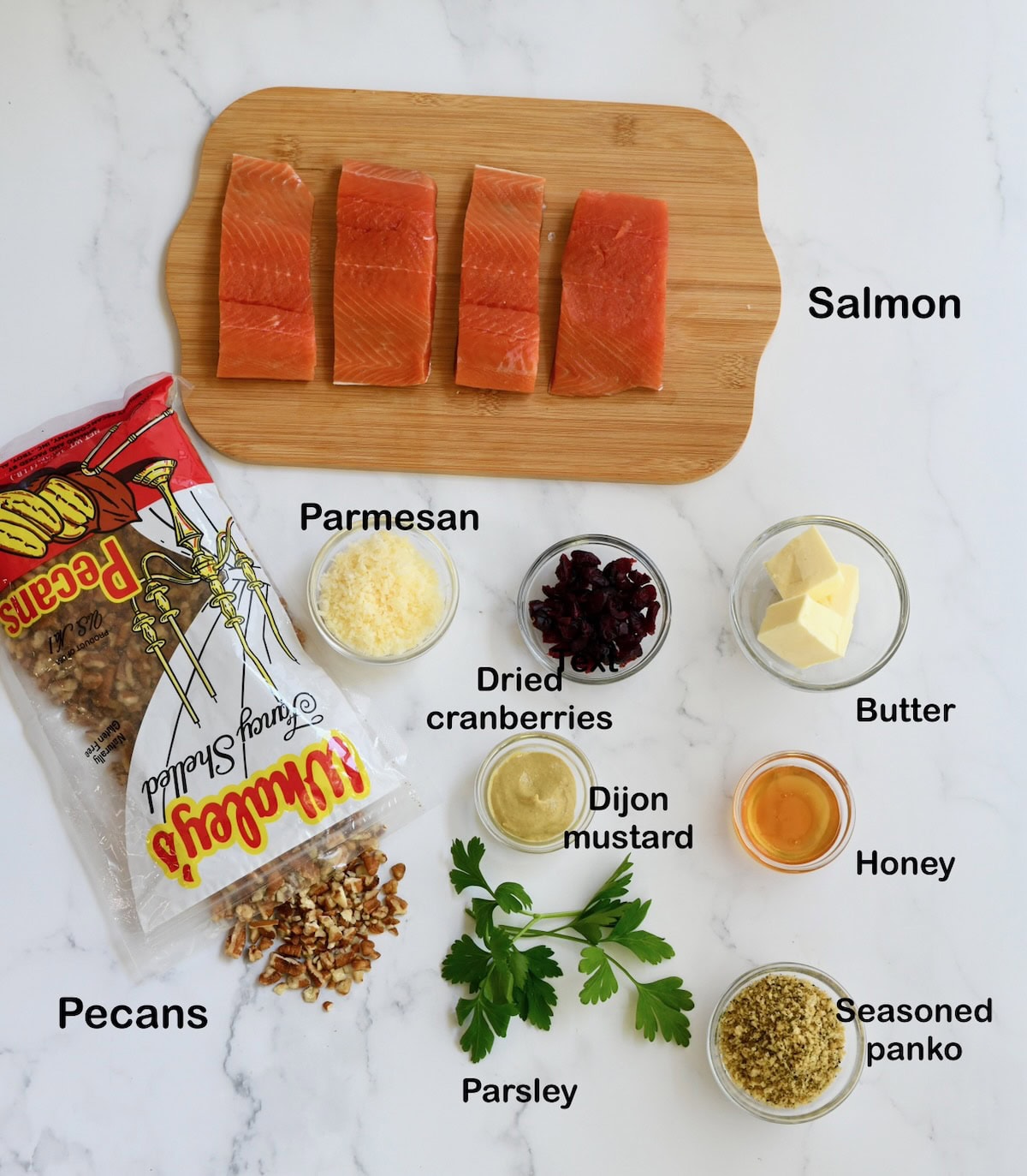 Ingredients for pecan-crusted salmon displayed on a marble surface