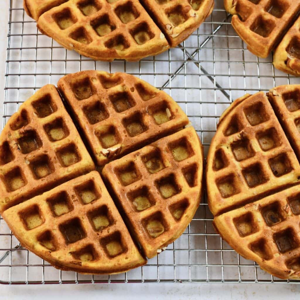 Pecan pumpkin waffles on a cooling rack.