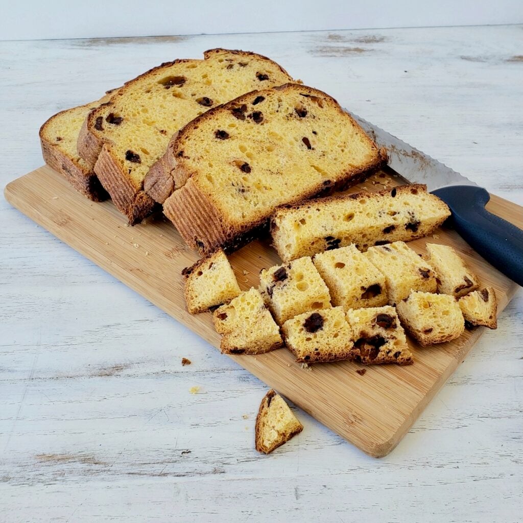 Sliced panettone bread on a wooden cutting board.