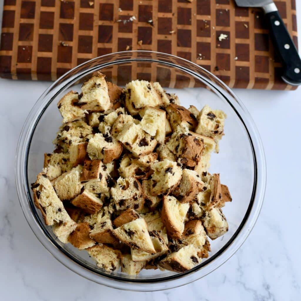 Sliced chocolate chip panettonne bread in a glass mixing bowl.