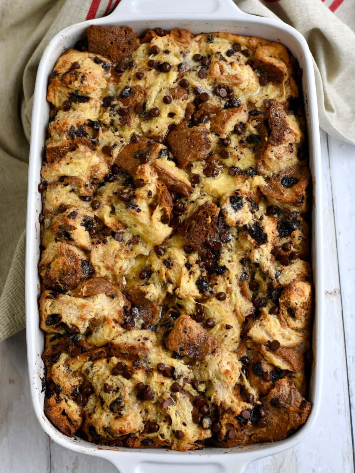 Overhead shot of finished panettone bread pudding in a white baking dish.