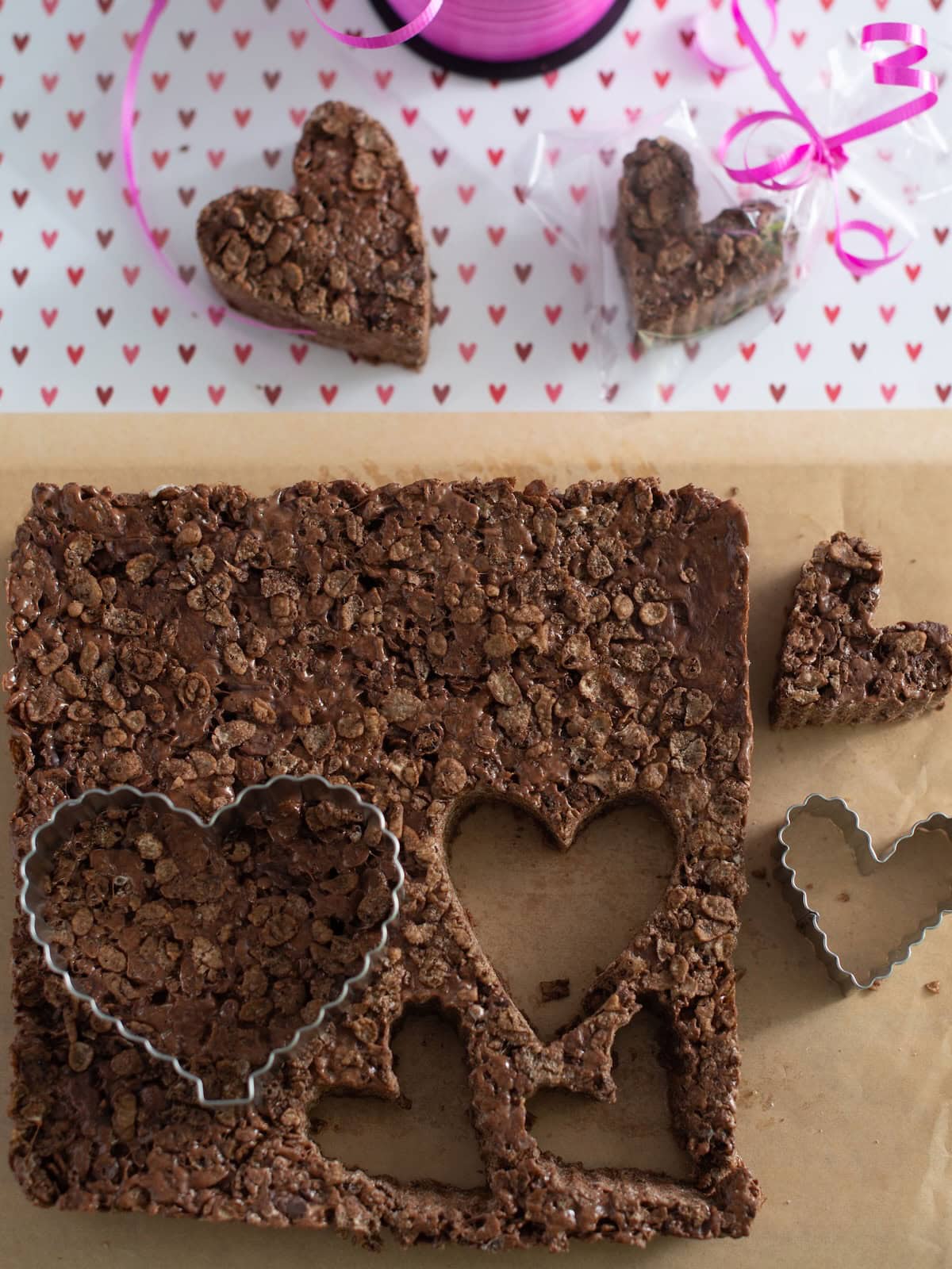 Cutting out heart shapes in the chocolate rice krispies to make heart shapes treats.