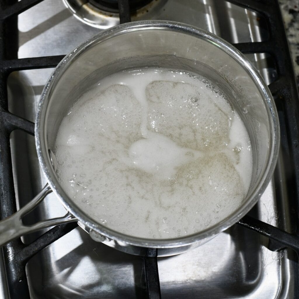 Boiling the pectin in water on the stove.