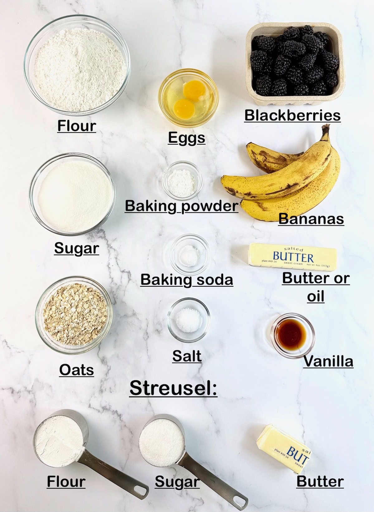 Ingredients needed to make banana blackberry muffins on a counter.