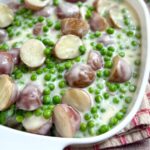 Finished creamed peas and potatoes in a baking dish.
