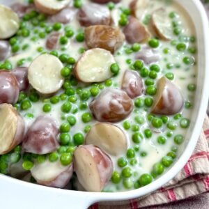 Finished creamed peas and potatoes in a baking dish.