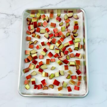 Freshly diced rhubarb on a sheet pan to freeze.