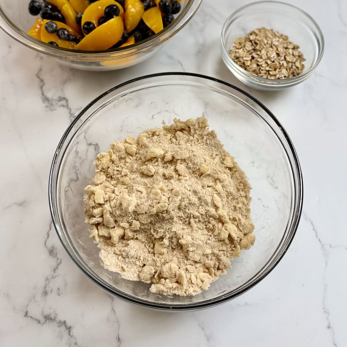 Cobbler topping mixed together in a glass mixing bowl.