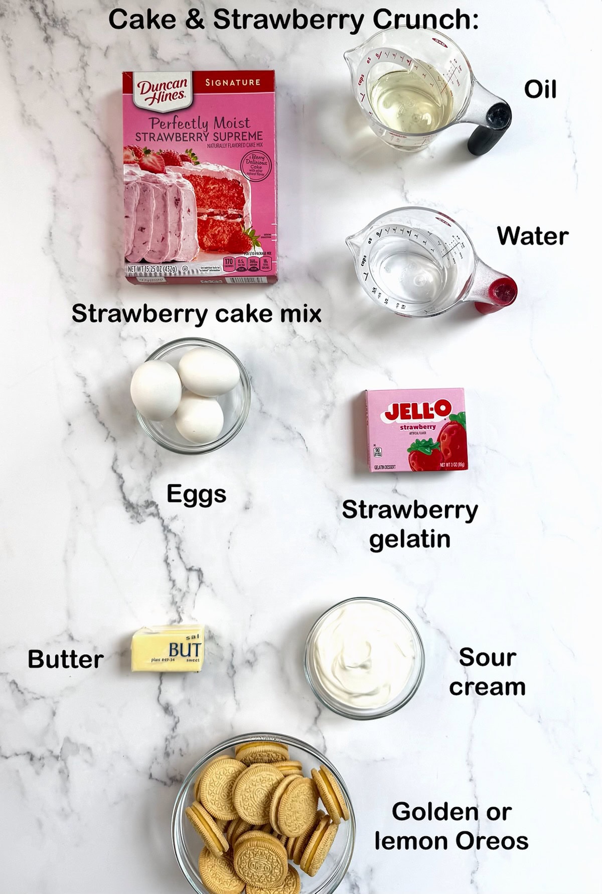 Ingredients needed to make strawberry crunch cake on a kitchen counter.