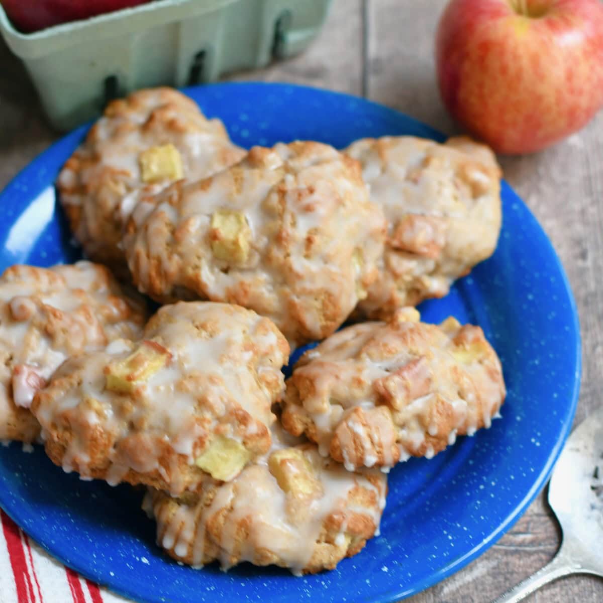 Apple fritters piled on a blue plate.