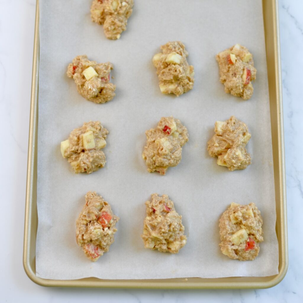 Apple fritter dough placed on sheet pan to bake.