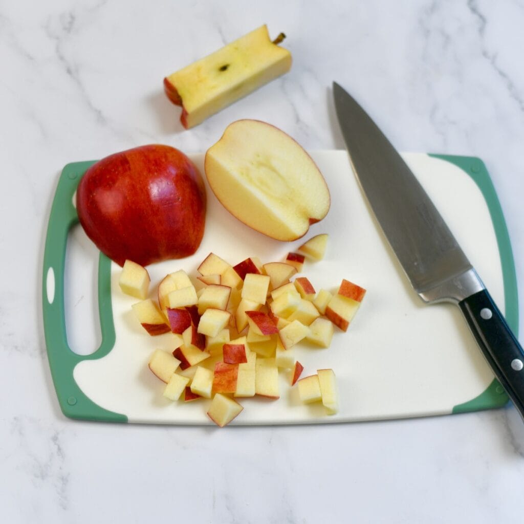 Dicing apples on a cutting board.