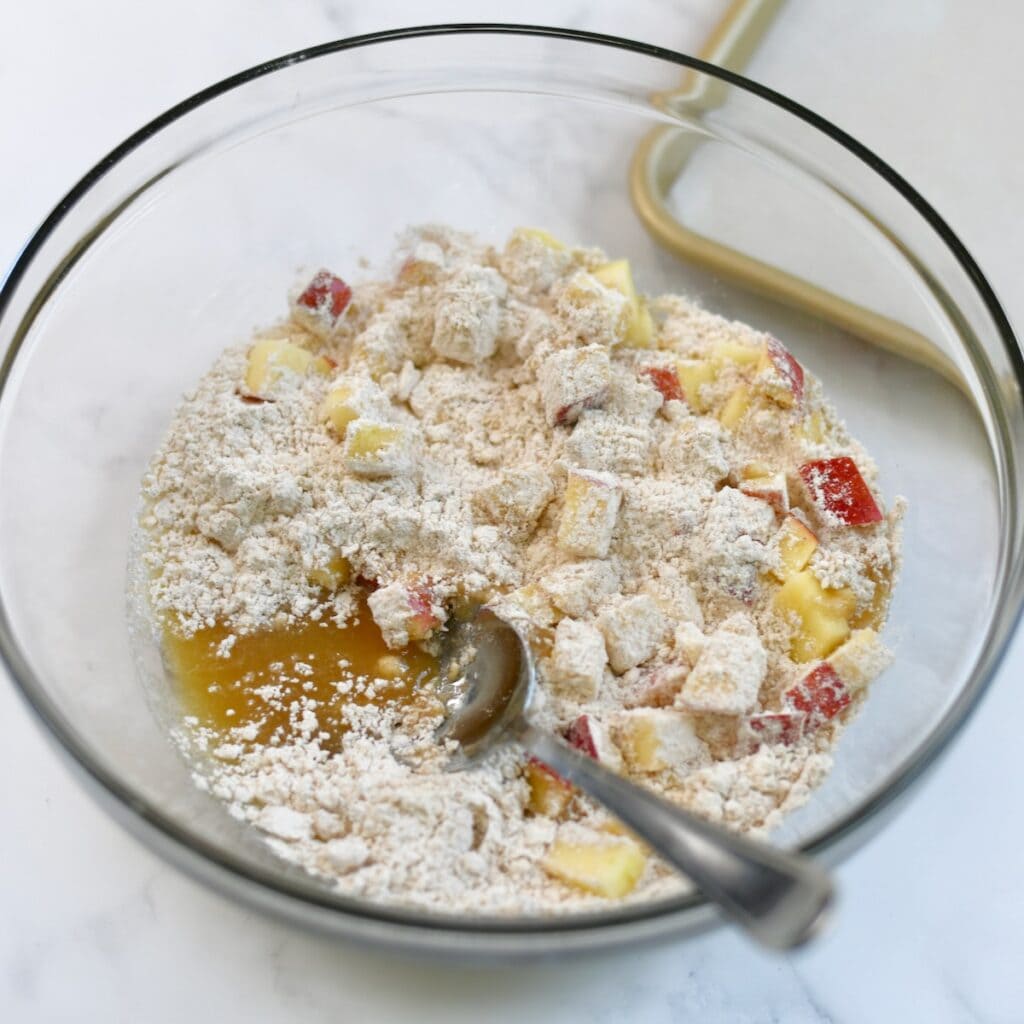 Mixing together the apple fritter dough in a mixing bowl.