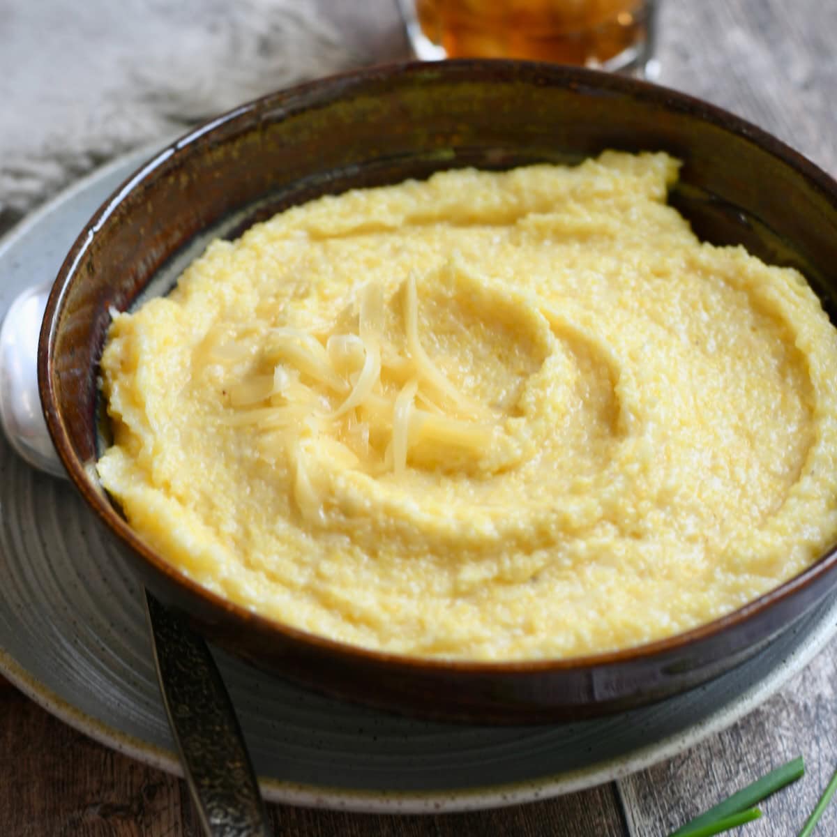 Gouda grits served in a bowl with extra cheese on top.