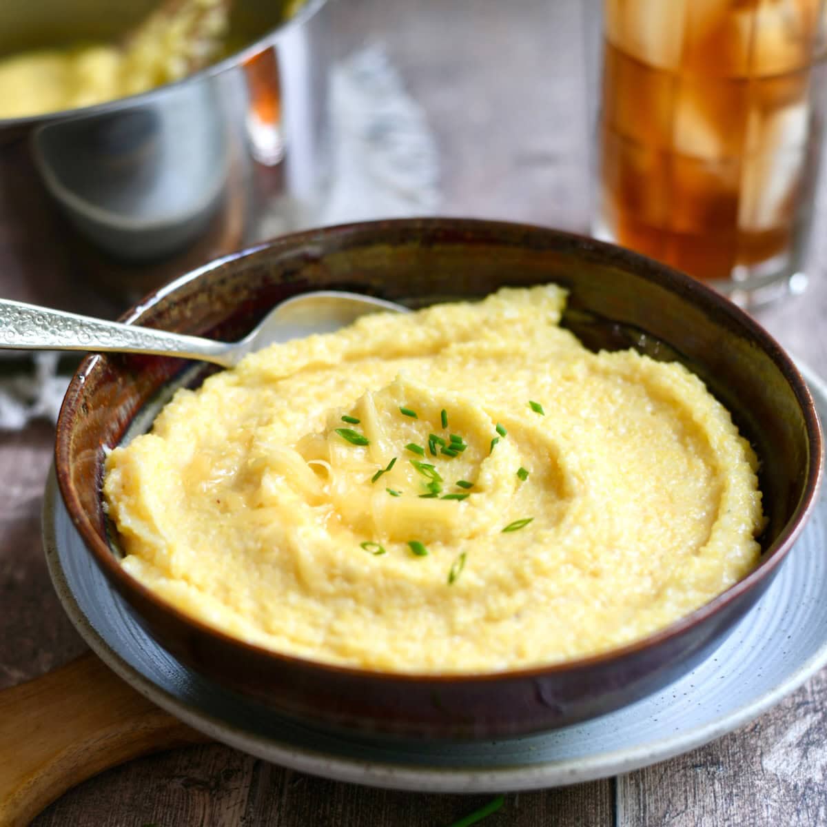 Side view of gouda grits served in a bowl with chives.
