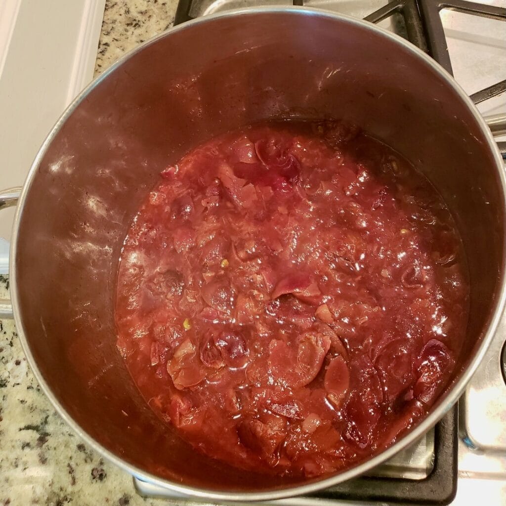 Muscadine grapes simmered down in a large pot.