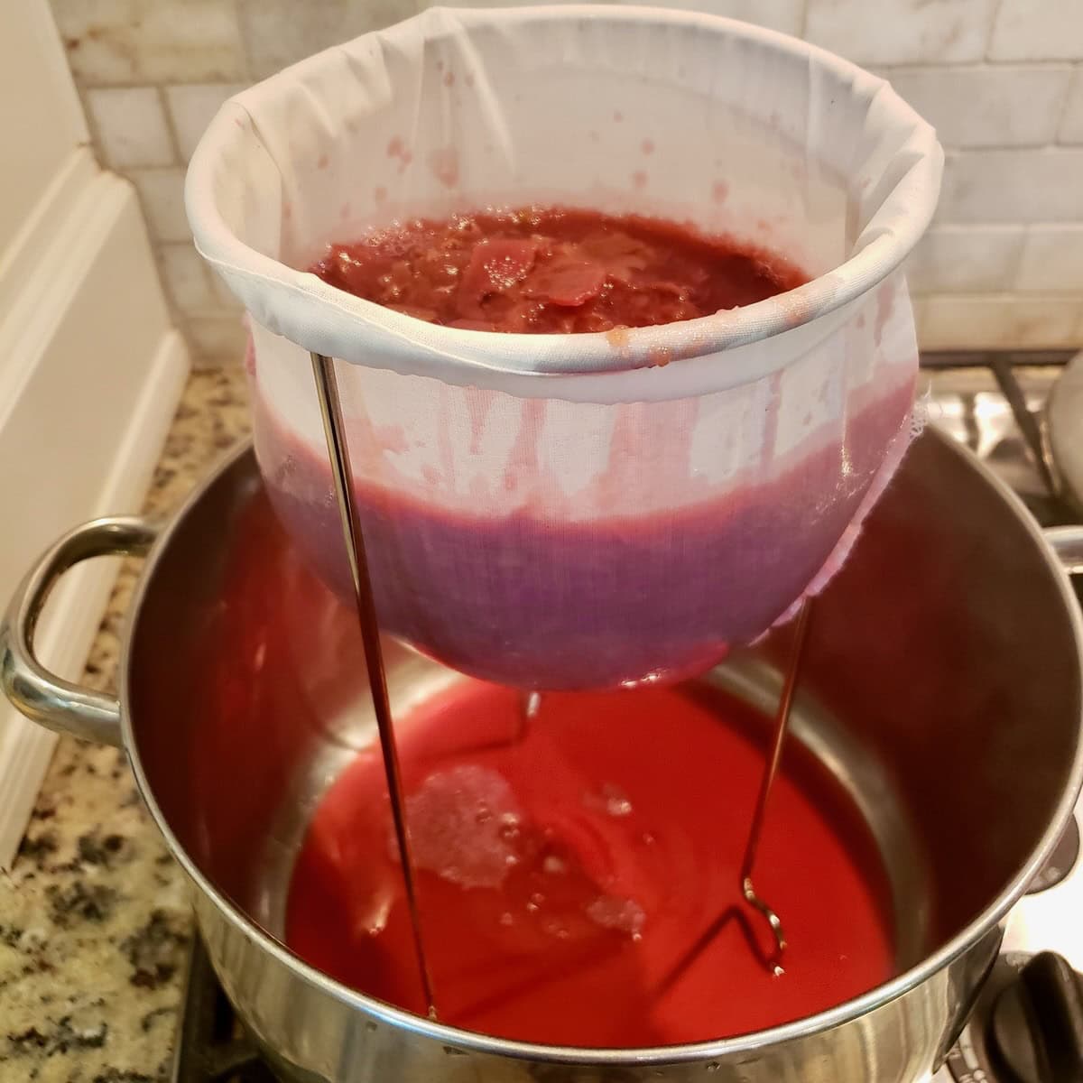 Muscadine juice being strained over cheesecloth.