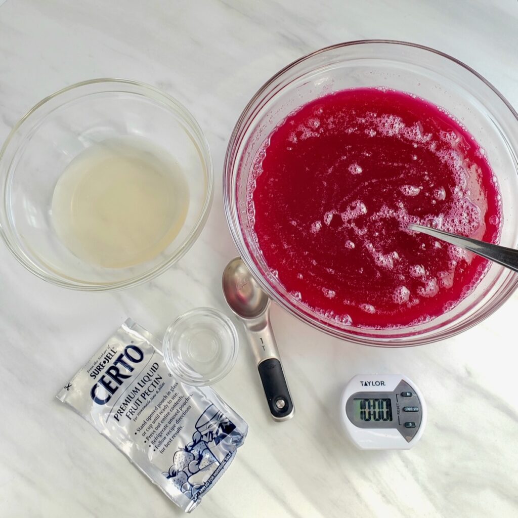 Muscadine juice in a bowl next to the certo pectin in a bowl.