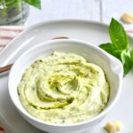 White bowl of pesto mayo.