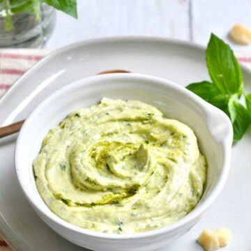 White bowl of pesto mayo.