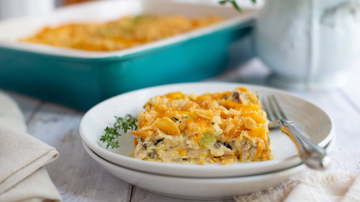 Chicken and wild rice casserole served on a plate with a fork.