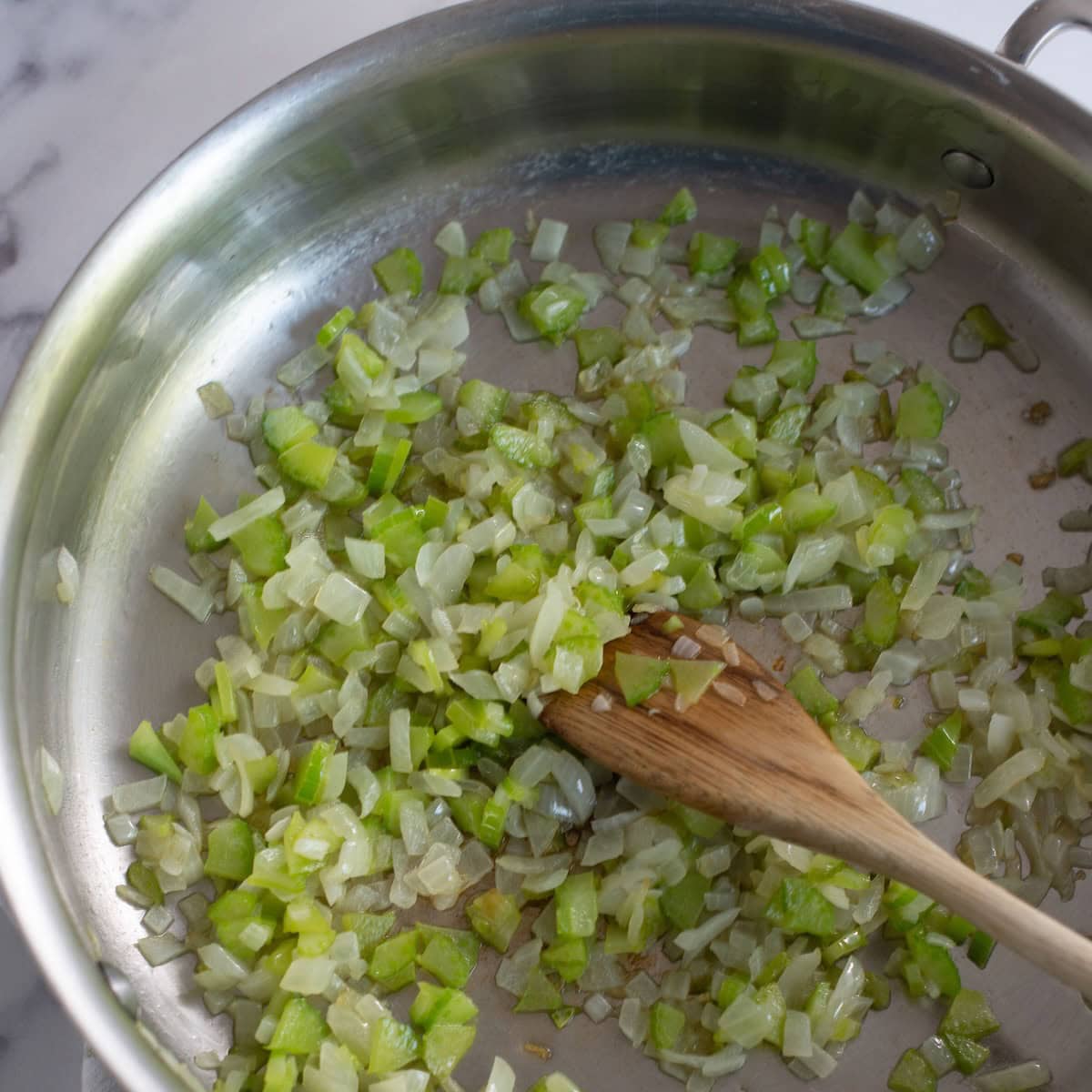 Sauteing onion and celery in a skillet.