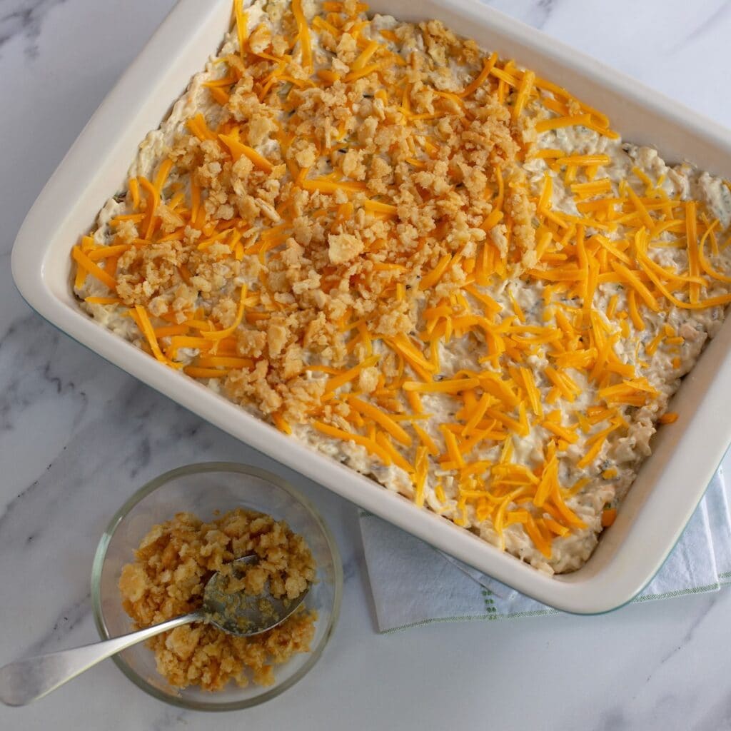 Sprinkling crusted Ritz crackers on top of the chicken wild rice casserole before baking.