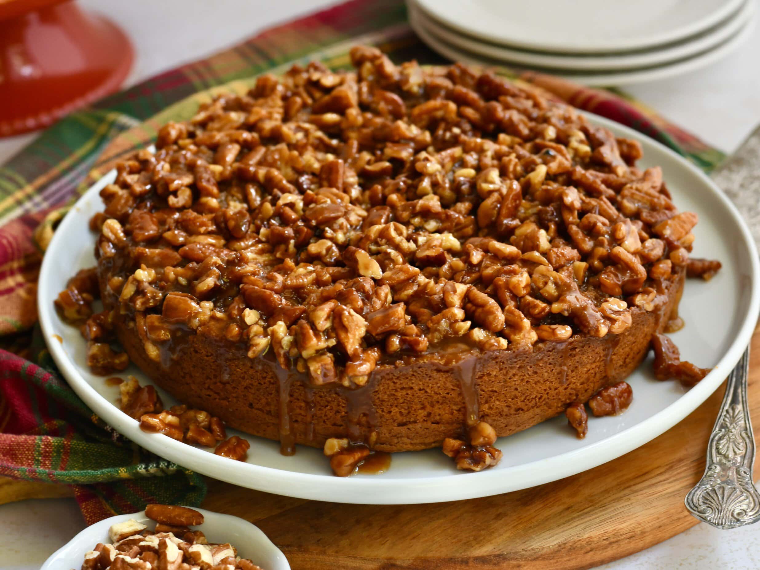 Pecan upside down cake on a serving plate.