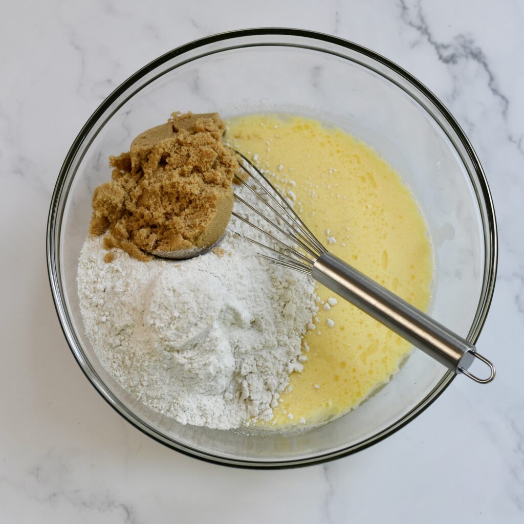 Combining the ingredients for cake batter in a mixing bowl.