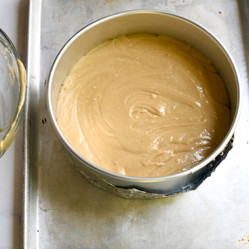 Cake batter placed in a springform pan before baking.