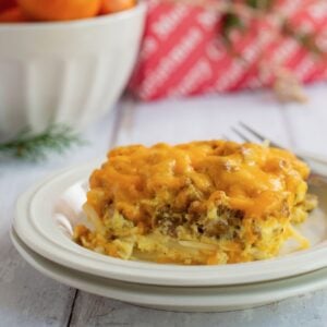 Side view of a square of sausage and hashbrown casserole on a plate.