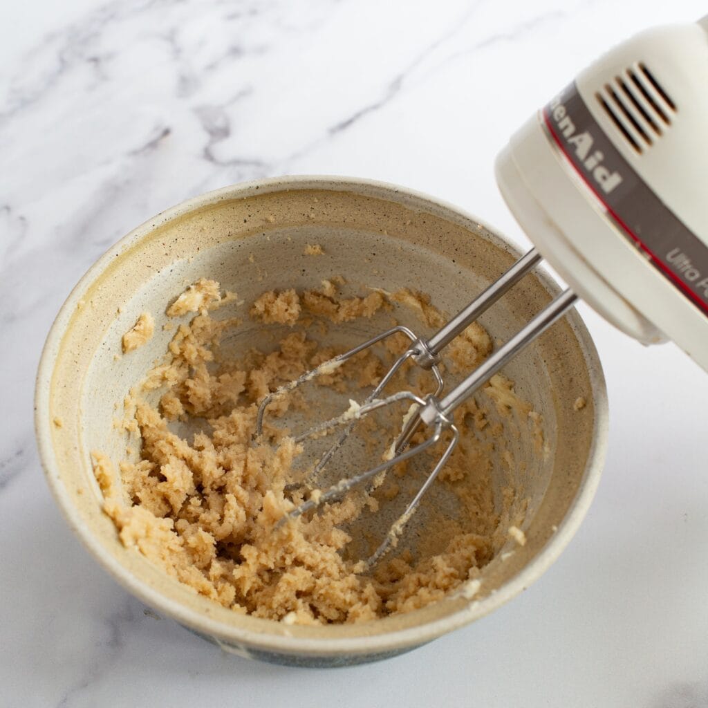Creaming the butter and sugar together in a bowl.