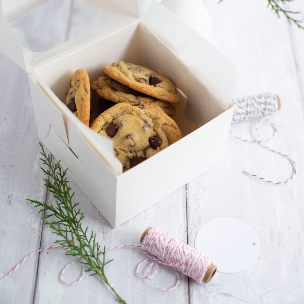 Small batch chocolate chip cookies placed in a white box for gifting.
